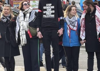 Thomas Abdullah Bourne (centre), 39, an Islamic convert who uses the social media handle 'White British Muslim', followed the Jewish comedian, 51, as he rode the elevator on the Tube