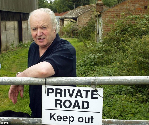 Mr Martin is pictured outside his farmhouse called Bleak House in Emneth Hungate, Norfolk, shortly after his release from prison in August 2003