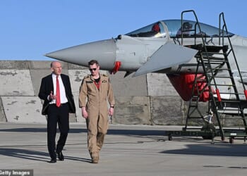 The British pilot who gunned down an Iranian drone (pictured with Defence Secretary John Healey) over Jordan celebrated with a beer at sunrise