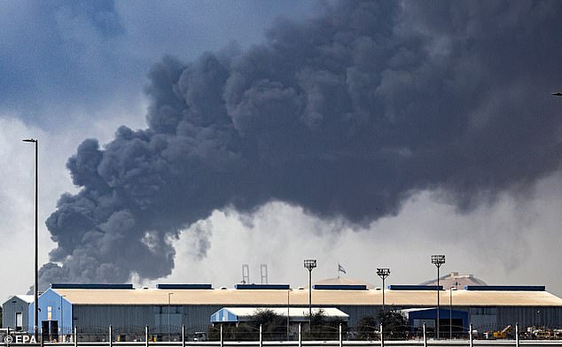 Thick black smoke billows from the Jebel Ali port in Dubai after it was struck by falling debris