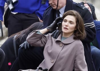 Pinned to the ground by a policeman in a London park, dishevelled Rachel Weisz appears distressed during a dramatic arrest (pictured)