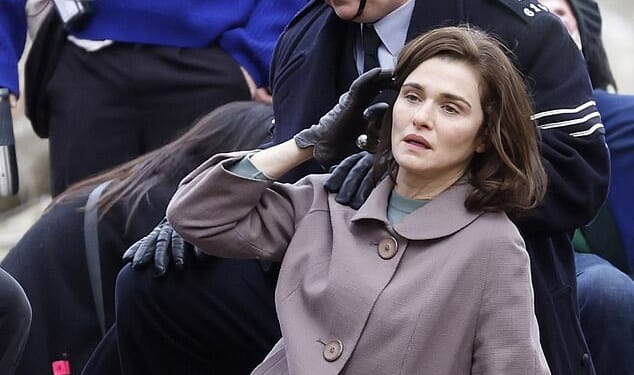 Pinned to the ground by a policeman in a London park, dishevelled Rachel Weisz appears distressed during a dramatic arrest (pictured)