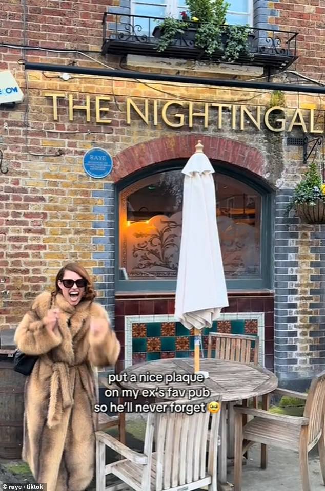 The video shows the laughing star clutching a pint of beer as she points out the sign, with the caption reading: 'put a nice plaque on my ex's fav pub so he'll never forget'