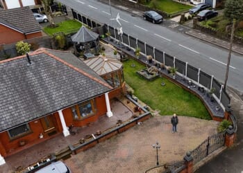 Retired couple forced to tear down £4,500 seven-foot tall privacy fence after neighbours complained it was more intrusive than the nine-foot high hedge it replaced