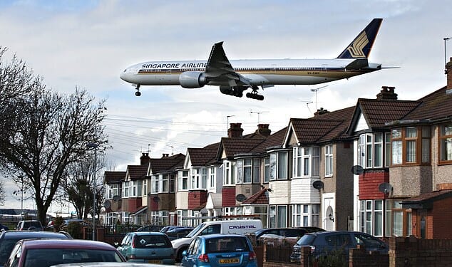 Pictured: A plane flies low over homes in south London on its approach to Heathrow Airport. Postcodes in Southall and Staines were ranked among the worst affected
