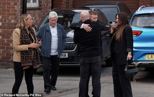 The family of Ricky Hatton leave Stockport Coroner's Court this afternoon following the inquest. Pictured: Hatton's brother Matthew hugs Hatton's son Cameron (centre right) as Matthew's partner Jenna Coyne (left) and Hatton's father Ray (second left) watch on