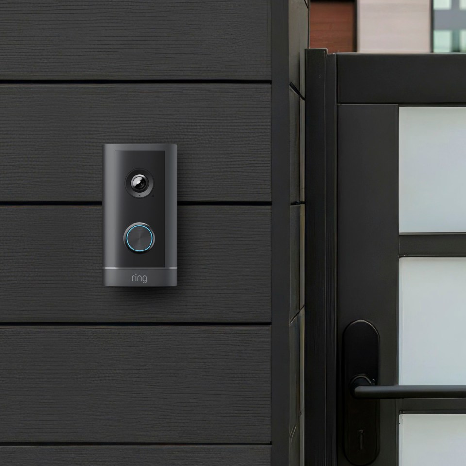 Ring video doorbell attached to a black wall.