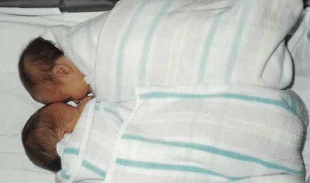 Sasha and her twin sister (above) were implanted in the wrong mother as IVF embryos