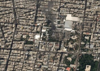 A satellite image shows black smoke rising and blackened buildings at Ayatollah Ali Khamenei's compound in Tehran