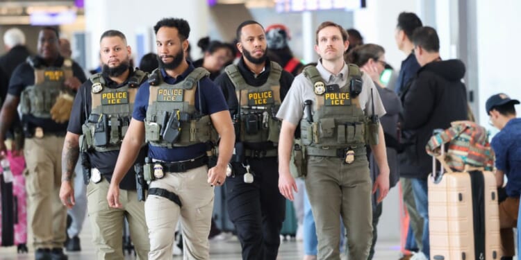 Immigration and Customs Enforcement agents walk through LaGuardia Airport in New York on March 23, 2026.