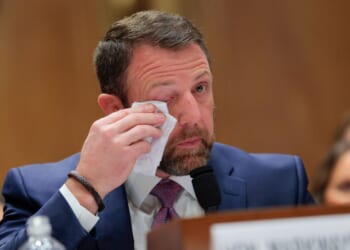Republican Sen. Markwayne Mullin becomes emotional as he testifies at a confirmation hearing in Washington, DC, on March 18, 2026.