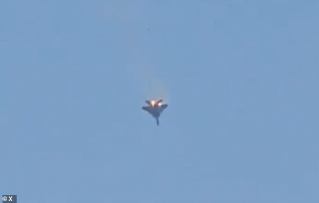 The pilot successfully ejected and was seen walking on the ground after the crash