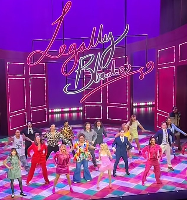 A still of a video filmed by an audience member shows Amber, in light pink, looking over to Hannah Lowther, front row second from left, having seemingly forgotten the choreography