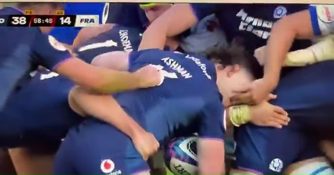 French rugby player appearing to eye gouge a Scottish rival during a Six Nations match.