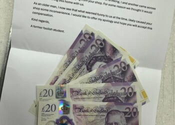 A bemused shop owner has received an anonymous letter and a £100 in cash to apologise for his sign being stolen 15 years ago