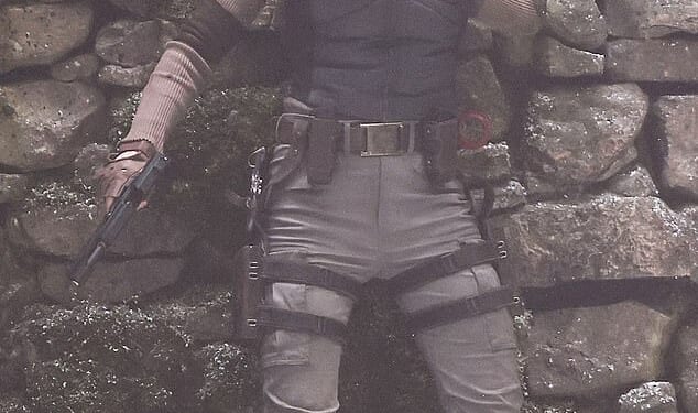 Sophie Turner threw herself into character Lara Croft on Monday as she wielded two guns while shooting dramatic Tomb Raider action scenes in Surrey