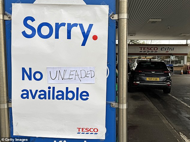 A sign telling motorists there is no unleaded petrol available at some of the fuel pumps is displayed at a Tesco supermarket in Southend