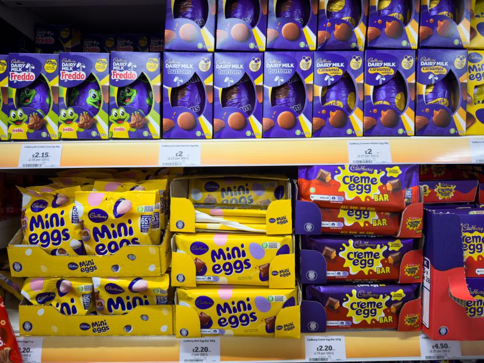 Easter eggs and other Cadbury chocolate products on display in a supermarket aisle.