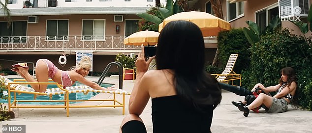 Posing on her hands and knees, Sydney Sweeney's character Cassie is seen bending back and forth as she locks eyes with the camera, held by Alexa Demie's character, Maddy
