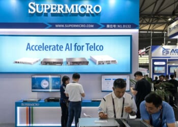 Attendees of the Mobile World Congress visit the Supermicro stand in Shanghai on June 18, 2025.