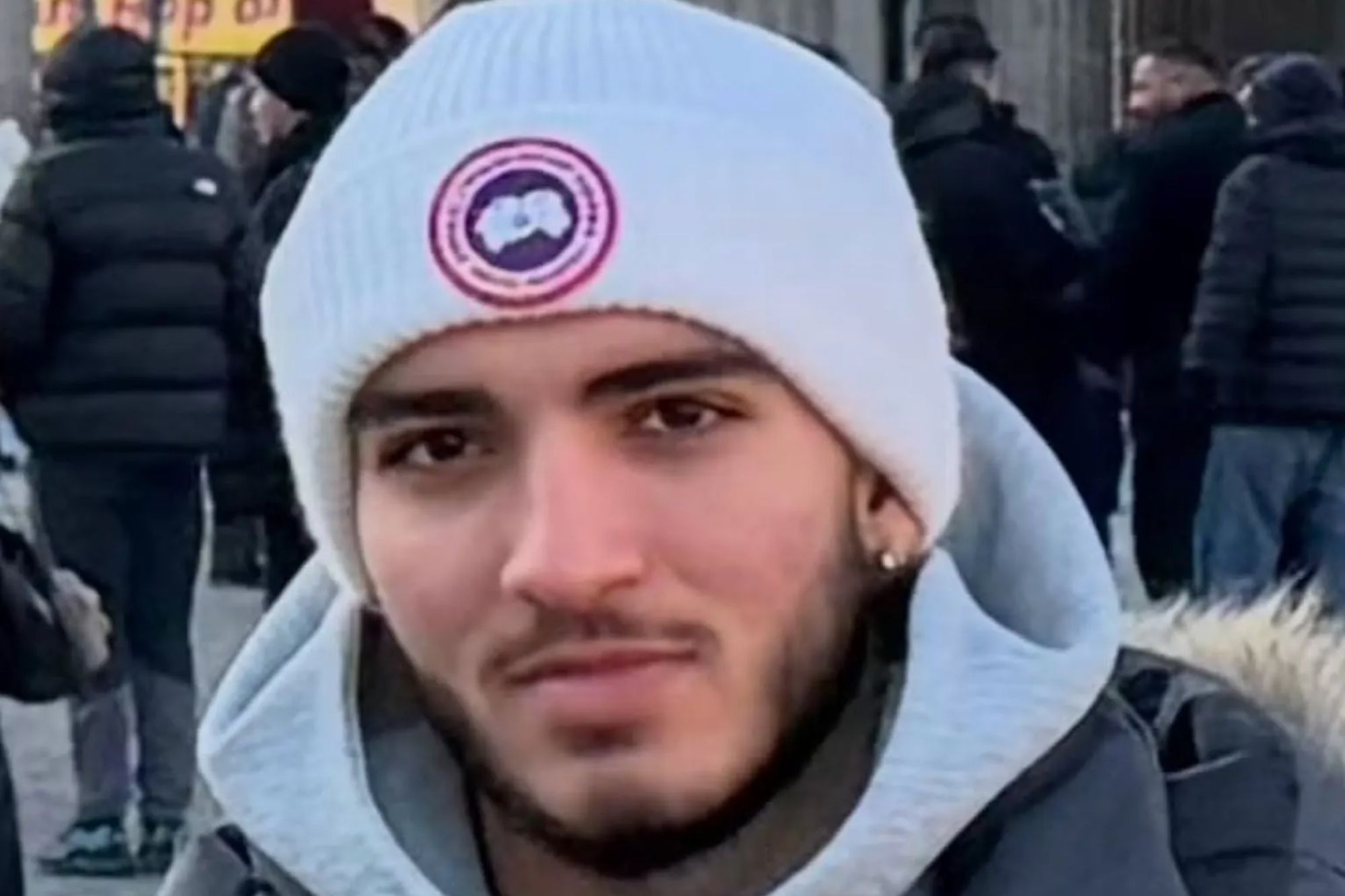 An image collage containing 1 images, Image 1 shows Berkan Demir, 18, in a white knit cap and dark puffer coat