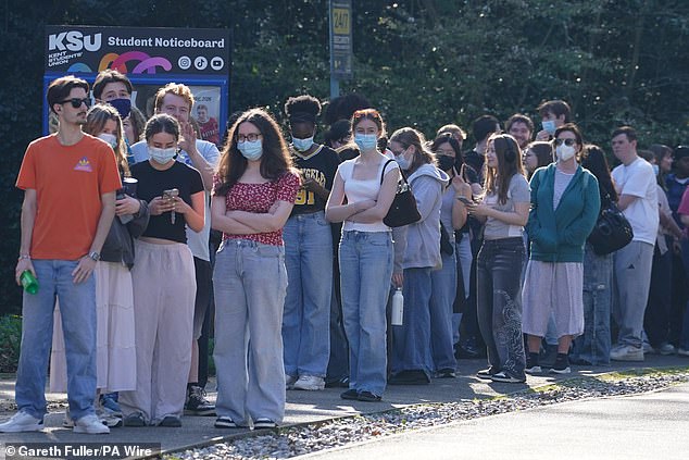 Students queuing to receive vaccines and antibiotics at the University of Kent campus in Canterbury on Thursday