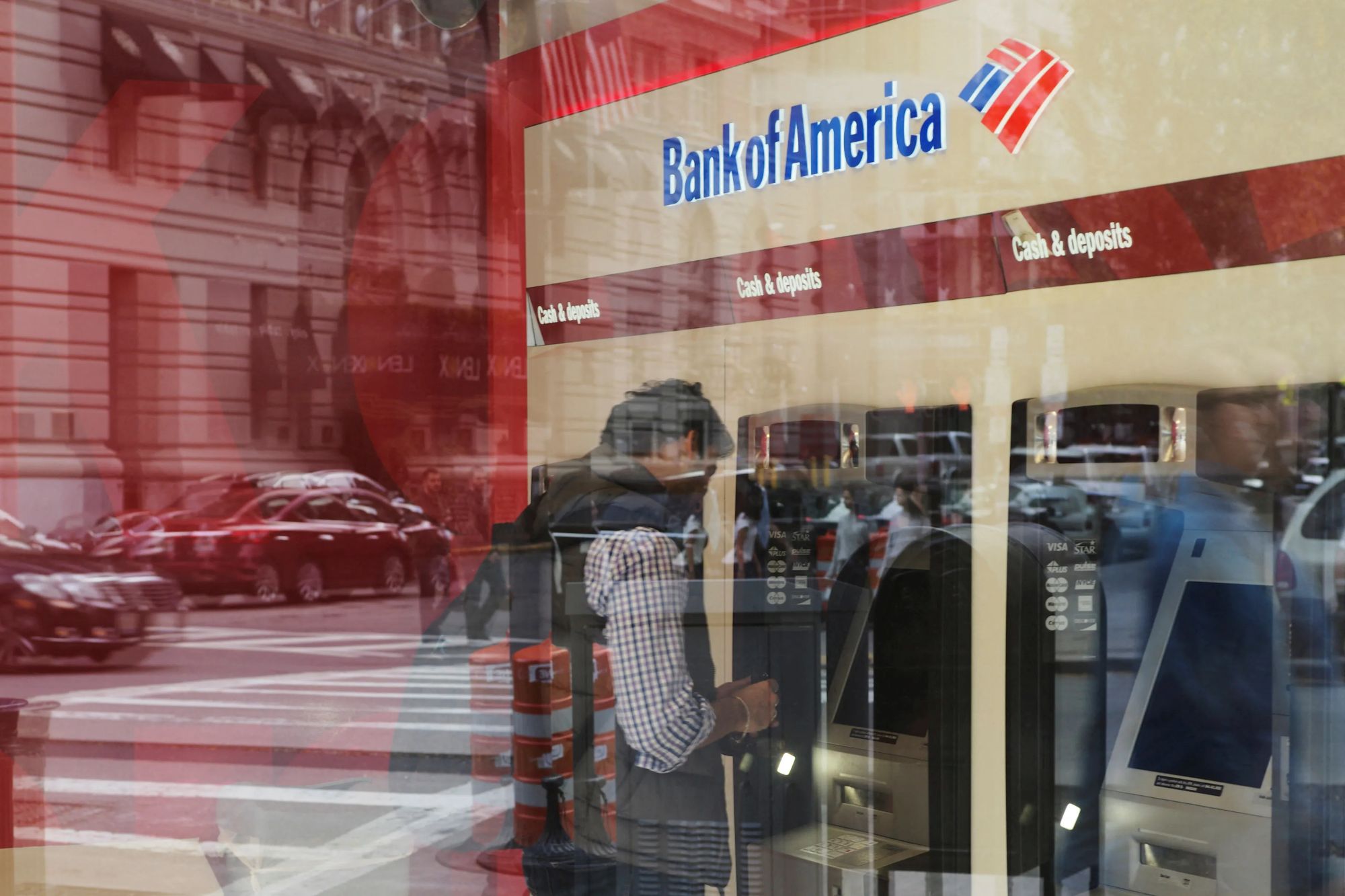An image collage containing 1 images, Image 1 shows : Customer uses an ATM at a Bank of America branch in Boston