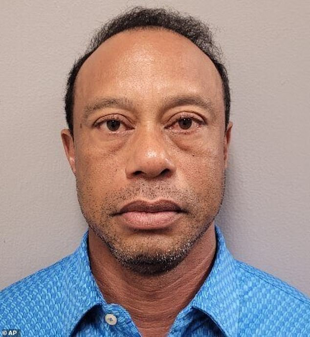 Woods stares down the lens in his police mugshot after being arrested for DUI on Friday