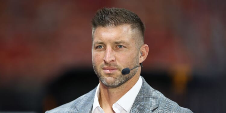 Tim Tebow sits on the set of SEC Network prior to the 2025 Aflac Kickoff Game between the Syracuse Orange and the Tennessee Volunteers at Mercedes-Benz Stadium on Aug. 30, 2025, in Atlanta, Georgia.