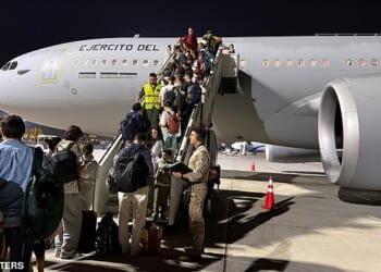 Spanish nationals pictured boarding a military repatriation flight in Oman on Wednesday. A British mercy flight failed to take off due to delays and then the pilot exceeding his hours