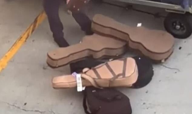 A careless baggage handler at LAX was captured tossing guitars on the floor while unloading a luggage cart on March 16
