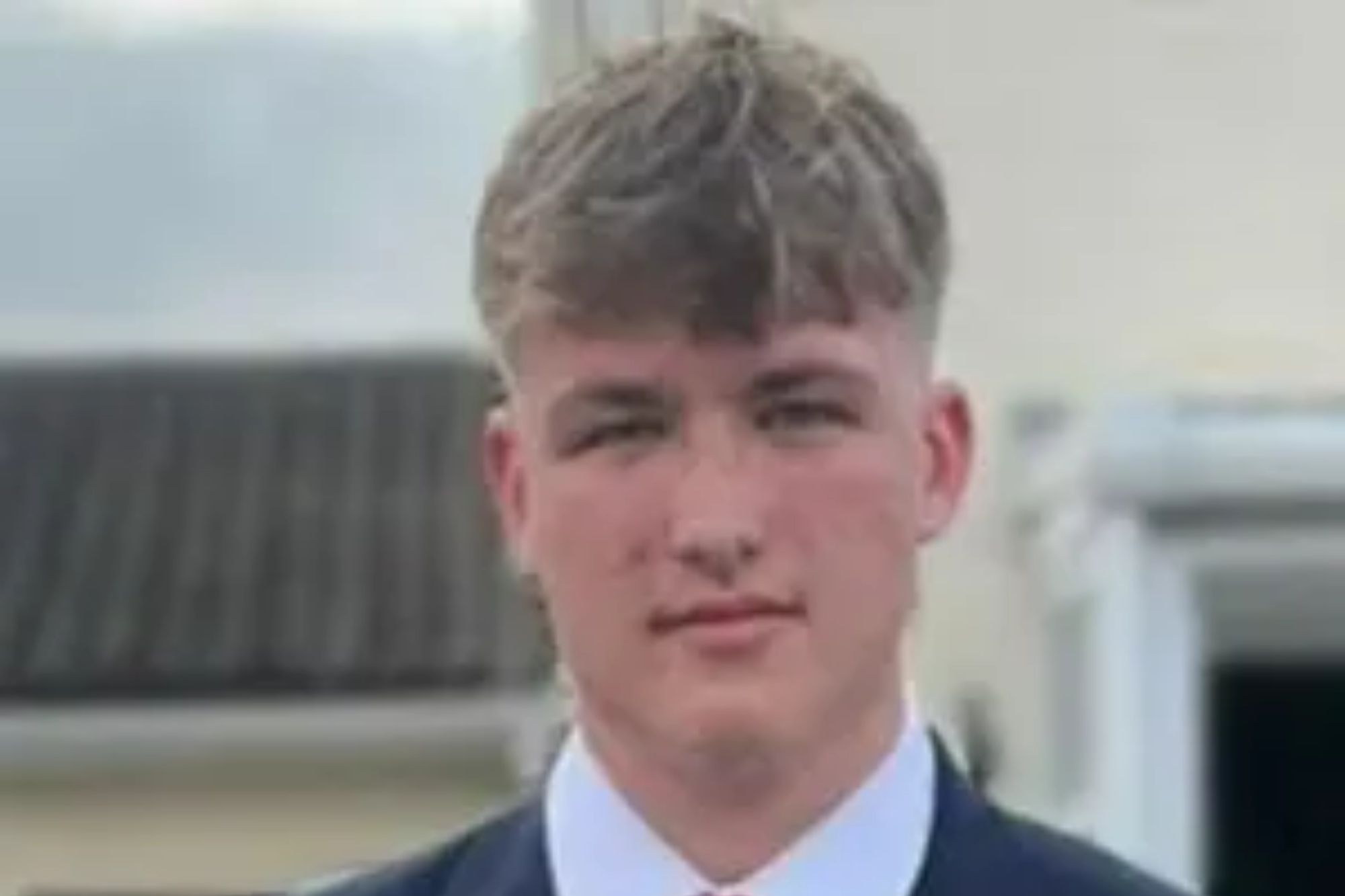 An image collage containing 1 images, Image 1 shows Joshua Blake in a suit and red tie