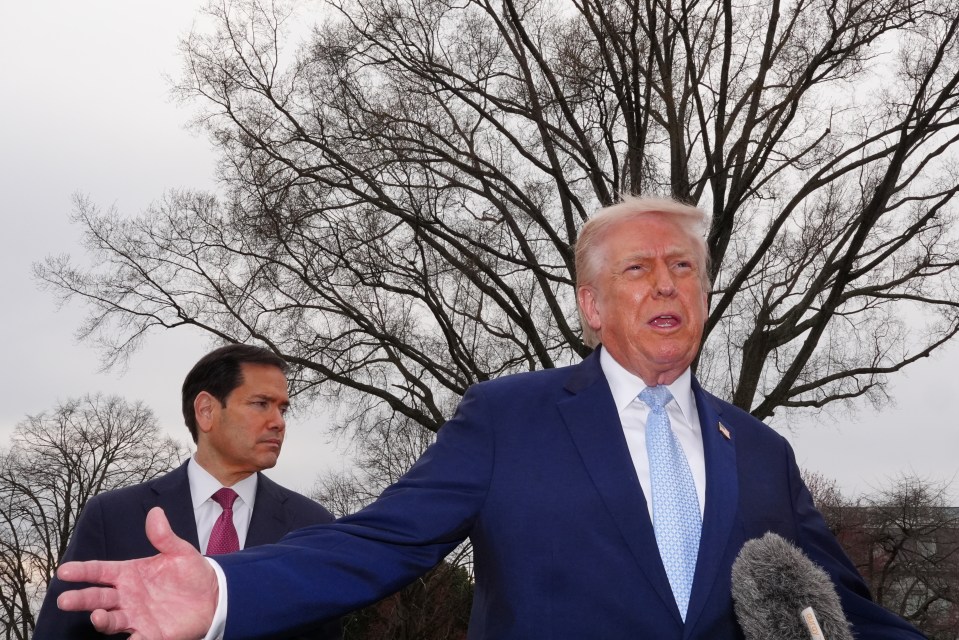 President Donald Trump speaks to reporters with Secretary of State Marco Rubio behind him.