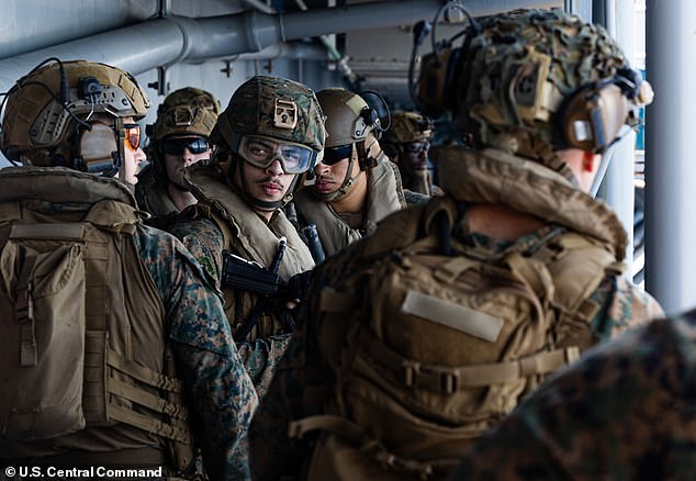 Officials said that the Pentagon is preparing for weeks of ground operations in Iran just shy of a full-scale invasion. Pictured: Sailors and Marine who arrived in the Middle East on Friday