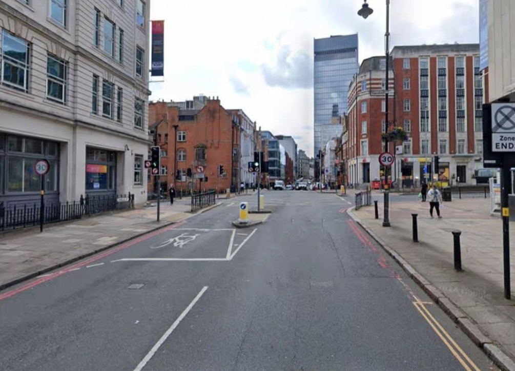 A street scene with buildings and a street leading into the distance.
