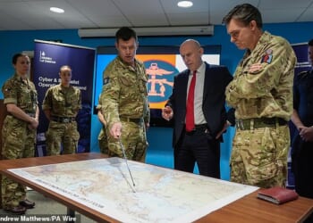 Defence Secretary John Healey is given a briefing as he meets military personnel during a visit to the Permanent Joint Headquarters in Northwood, North West London, today