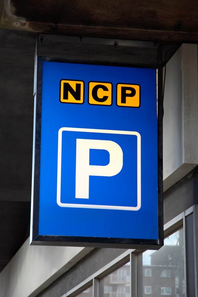 An NCP parking sign with a blue background and yellow "NCP" text above a white "P" symbol.
