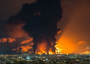 A large plume of smoke rises at the site of multiple airstrikes on an oil depot in Tehran on March 7, 2026.