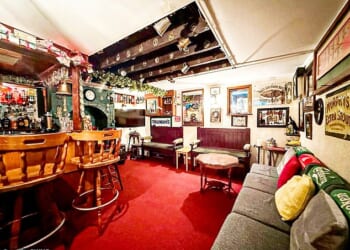 The basement is fully decked out like a pub with a fully stocked bar