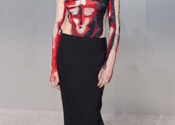 English model Cara Delevingne, 33, arrived in a long-sleeve bodysuit that was adorned with red, black and white sequins to resemble a male torso. She finished the look with a black pencil skirt and wore her hair in a slick updo