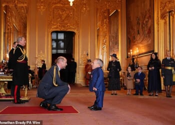 Warwick Davis was supported by a mystery woman as he accepted his OBE on Wednesday, after crediting a woman called 'Sponge' for 'helping him love again' following his wife's death