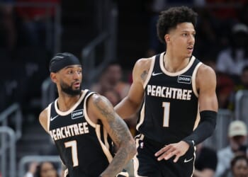 Jalen Johnson and Nickeil Alexander-Walker of the Atlanta Hawks react against the Philadelphia 76ers during a game at State Farm Arena on March 7, 2026, in Atlanta, Georgia.