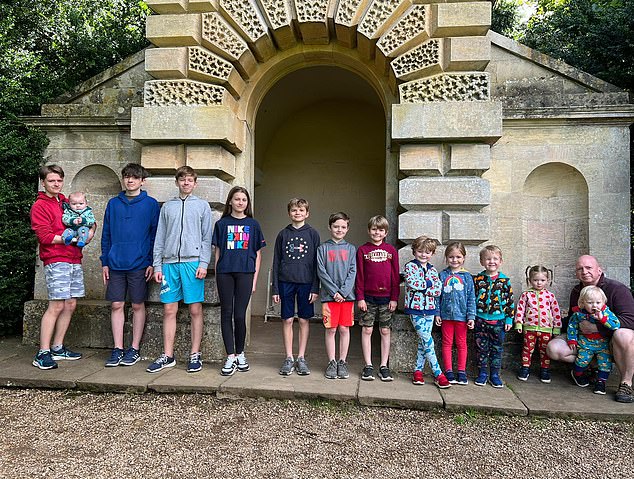 Oliver, far left, with the 13 children. ‘I think Oliver’s calling was to be a father,' says Natalie
