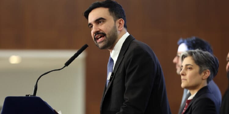 New York City Mayor Zohran Mamdani speaks into a microphone at a community meeting last week at New York City's Fordham University.