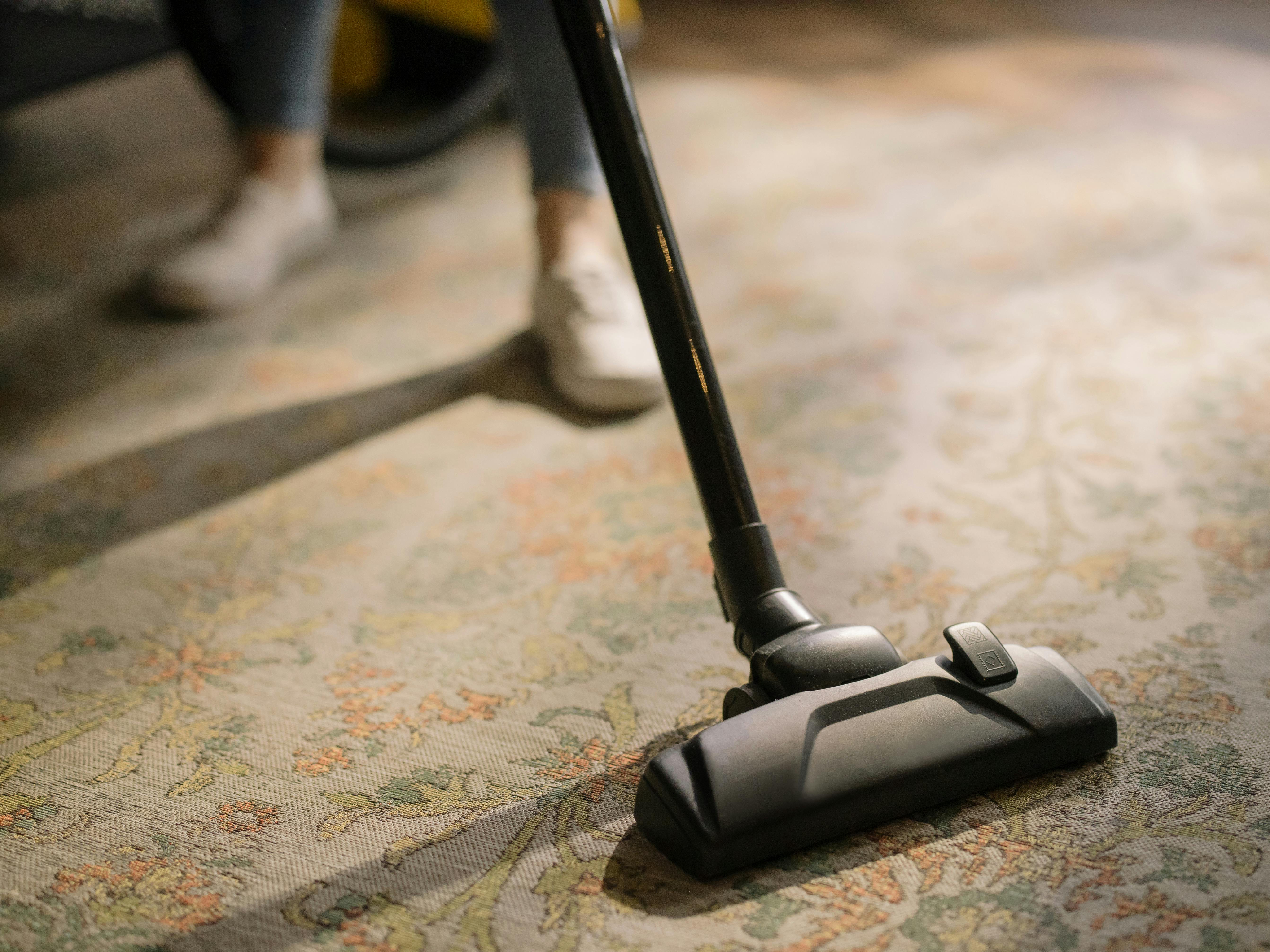 Cordless vacuum cleaner on patterned carpet.