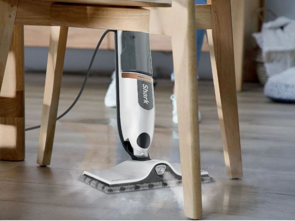 Shark steam mop cleaning a wooden floor.