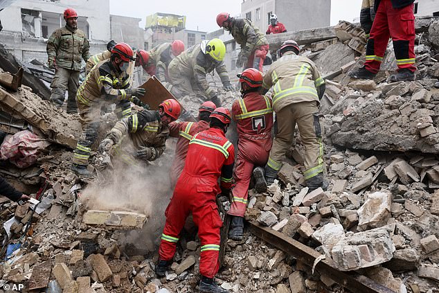 Rescue workers search for survivors in the rubble after a strike in southern Tehran