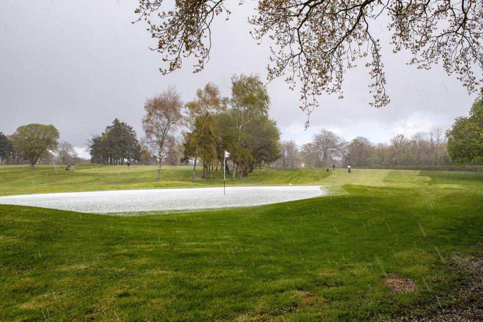 A green at the Dinsdale Spa Golf Club is covered in hailstones during an annual golf day.
