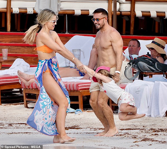 Evidently in high spirits, Vogue indulged playful daughter Gigi by swinging her circles while Spencer cheered her on