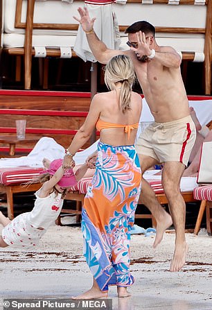 The TV personality leapt in the air as Vogue played with their young daughter